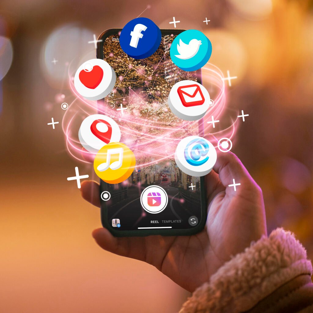Hand holding a smartphone with floating social media icons like Facebook, Twitter, email, music, and location, representing digital marketing and online engagement.